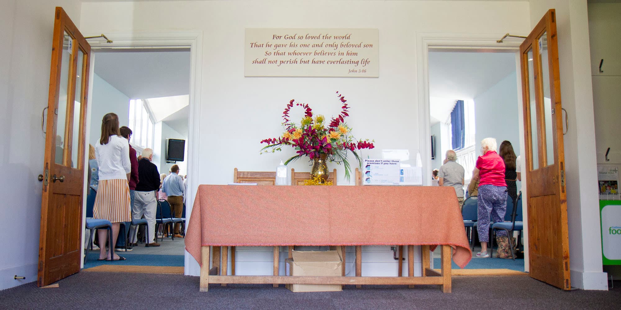 The church foyer with flowers, looking into the main hall