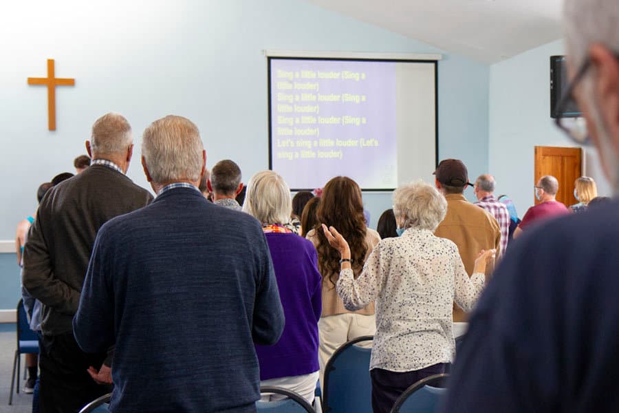 The congregation standing to sing during a Sunday service